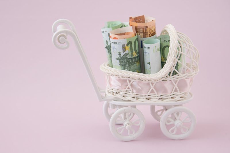Foto: Miniaturkinderwagen mit Geldscheinen